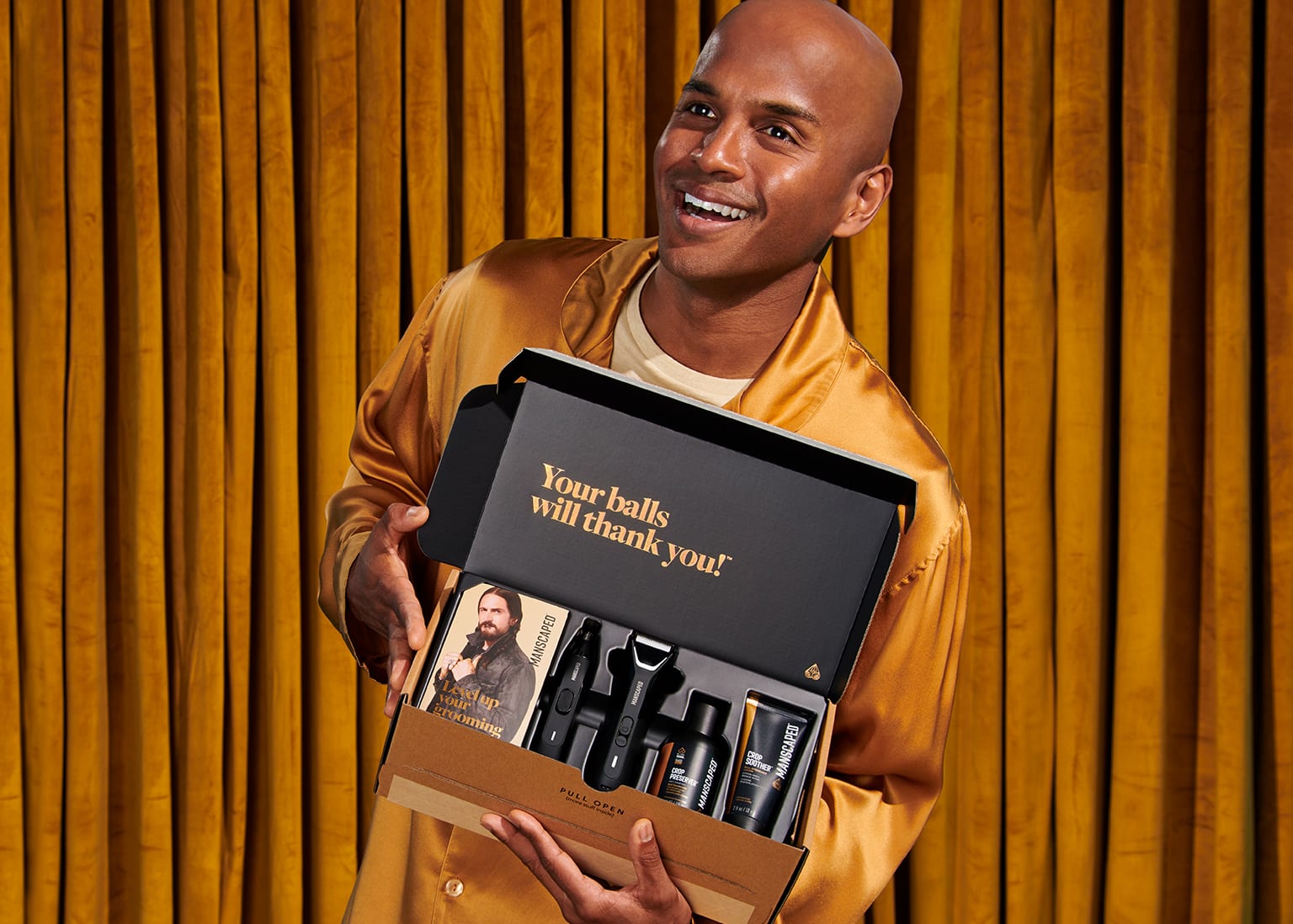 Male model in golden suit holding the Performance Package in his hands